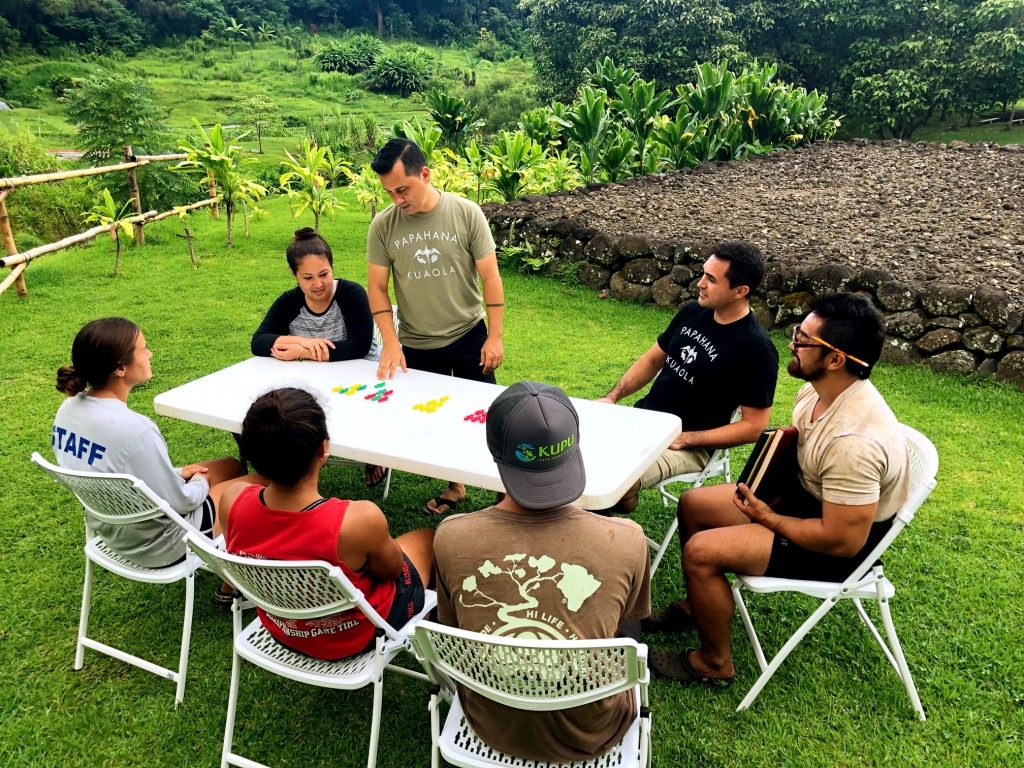 Keoni leading a community meeting outdoors