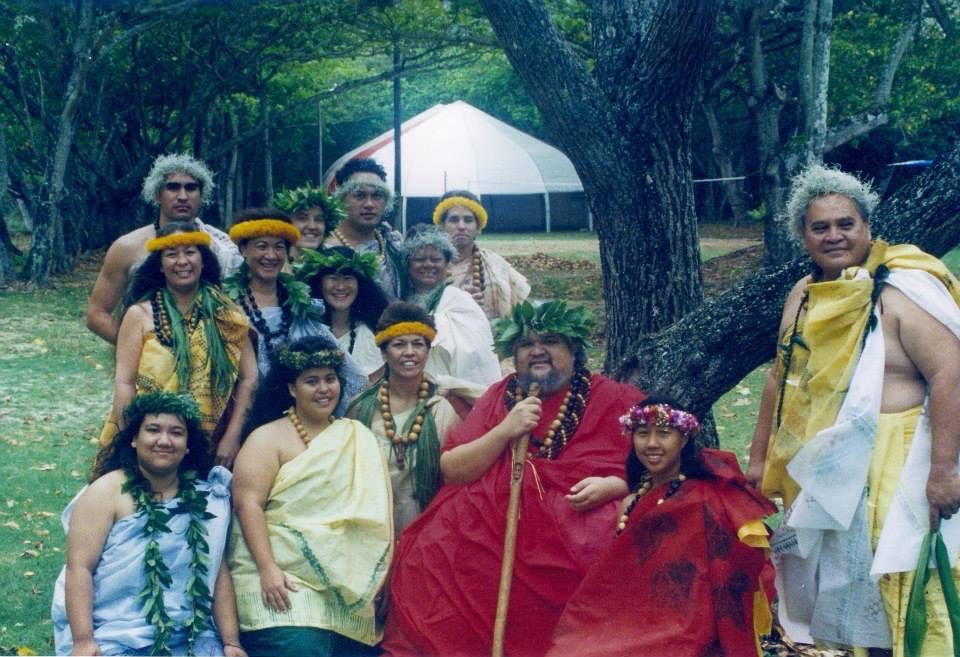 Keoni with his hālau in ceremonial regalia