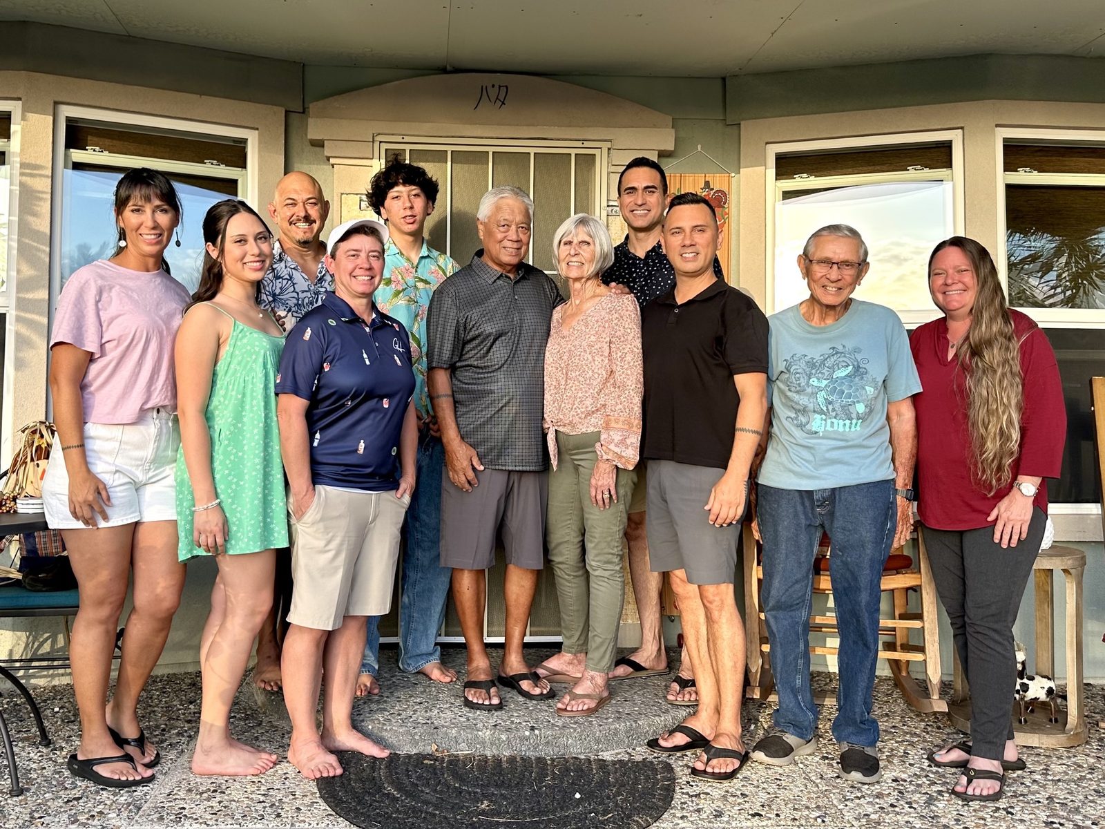 Keoni with his extended family gathered on a porch