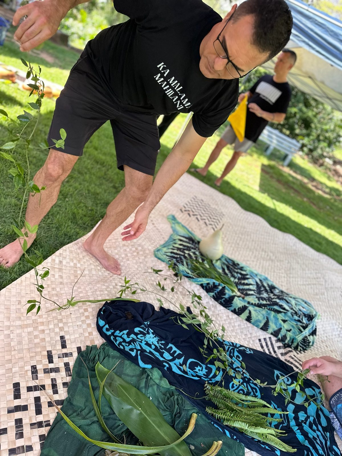 Keoni preparing an offering of lāʻī